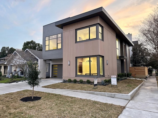 contemporary house with a garage and a yard