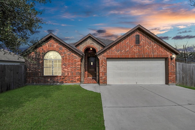 view of front of house featuring a garage and a lawn