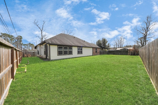 rear view of property featuring a yard