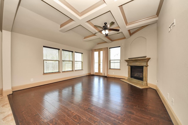 unfurnished living room featuring hardwood / wood-style flooring, ceiling fan, coffered ceiling, and beam ceiling