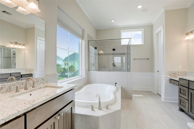 bathroom featuring vanity, ornamental molding, and independent shower and bath