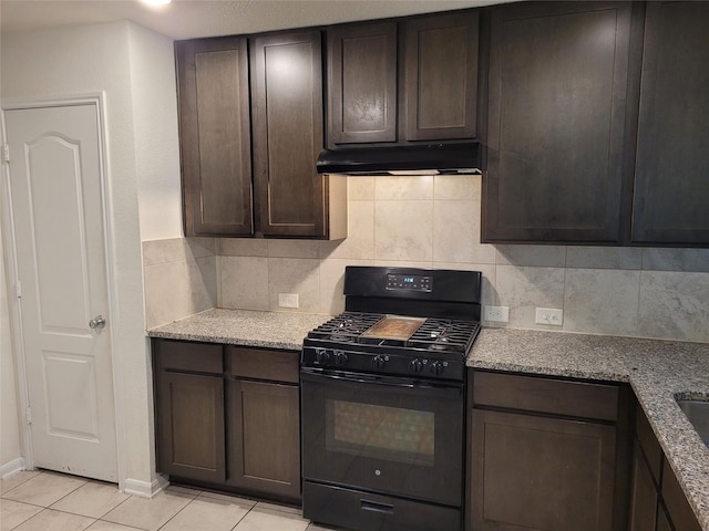 kitchen with gas stove, light stone counters, and dark brown cabinetry