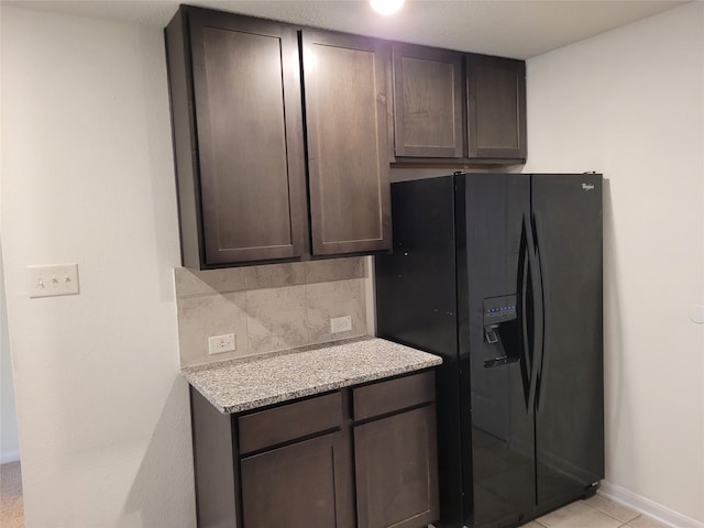 kitchen with black fridge with ice dispenser and dark brown cabinets