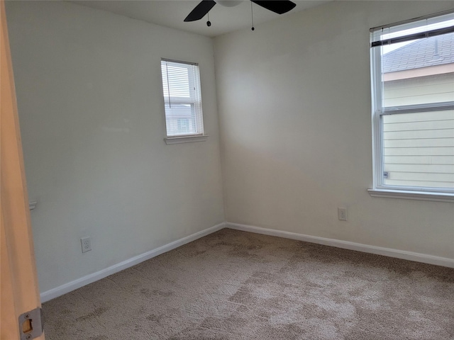 carpeted empty room featuring ceiling fan