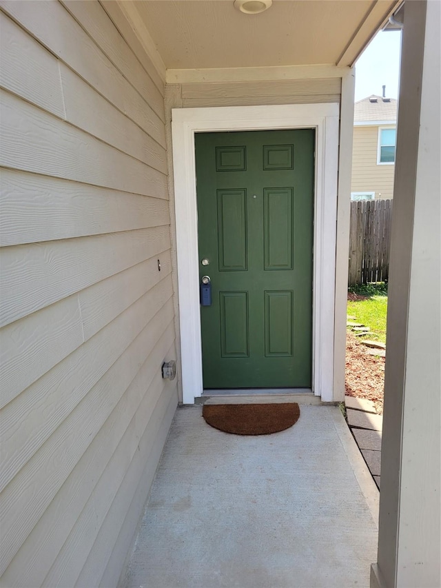 view of exterior entry with fence