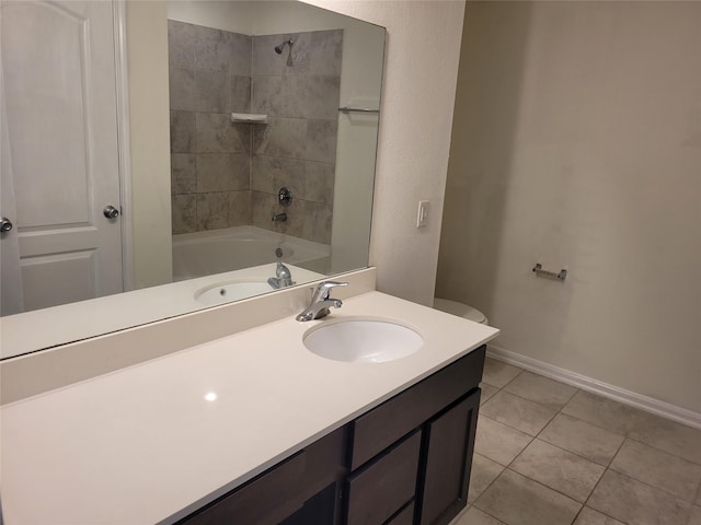 bathroom featuring tile patterned floors, vanity, baseboards, and bathing tub / shower combination