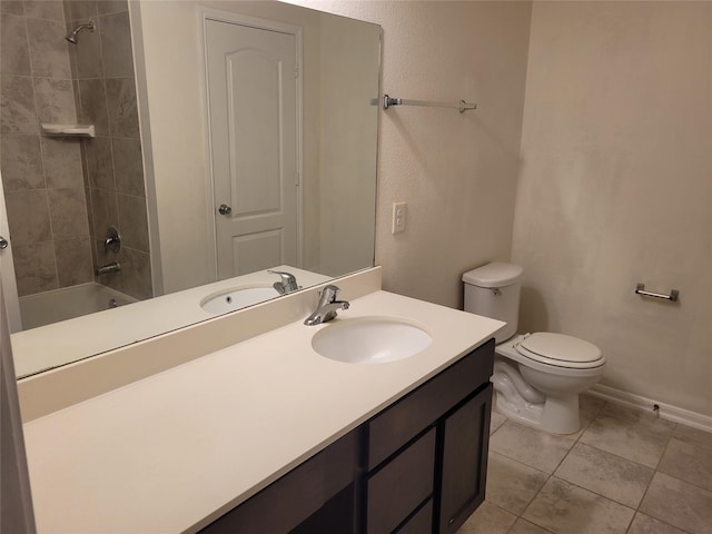 bathroom featuring baseboards, toilet, vanity,  shower combination, and tile patterned flooring