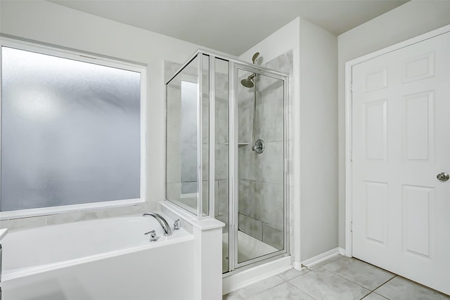 bathroom with tile patterned floors and separate shower and tub