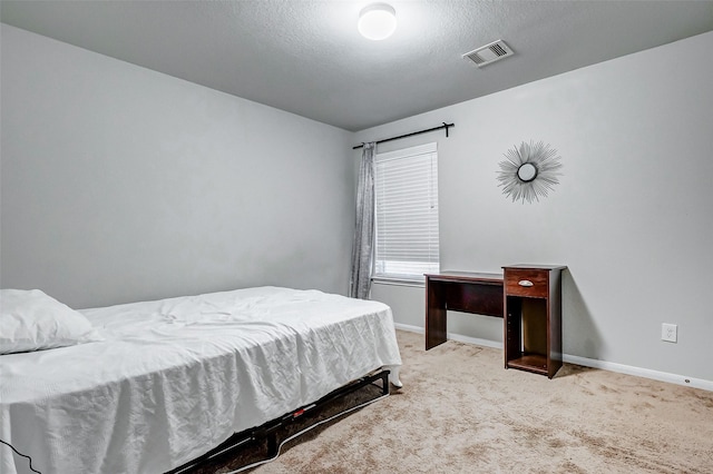 carpeted bedroom with a textured ceiling