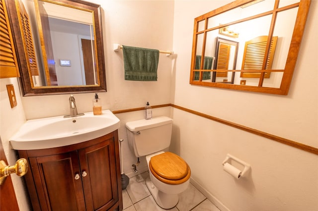 bathroom with tile patterned floors, vanity, and toilet