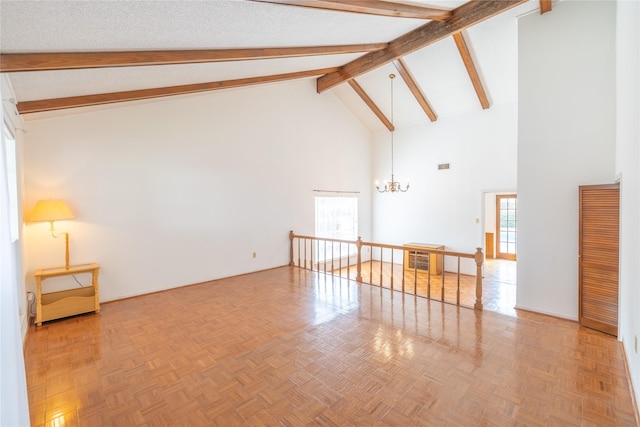 unfurnished living room featuring a healthy amount of sunlight, parquet floors, and a notable chandelier