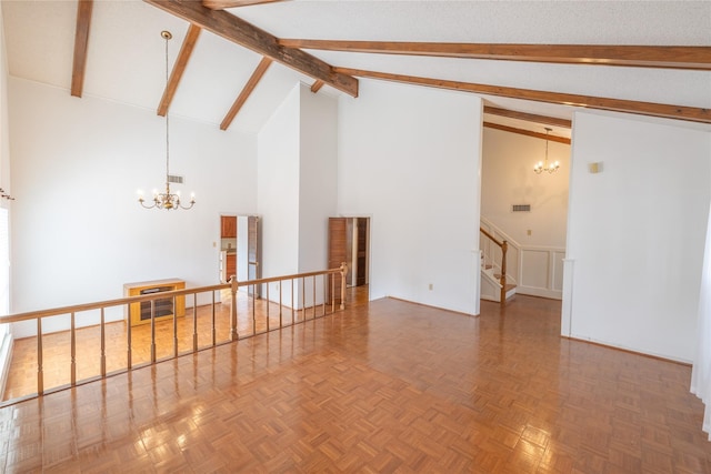 unfurnished room with parquet floors, beam ceiling, a chandelier, and high vaulted ceiling