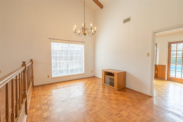 unfurnished room with beamed ceiling, high vaulted ceiling, light parquet floors, and a notable chandelier