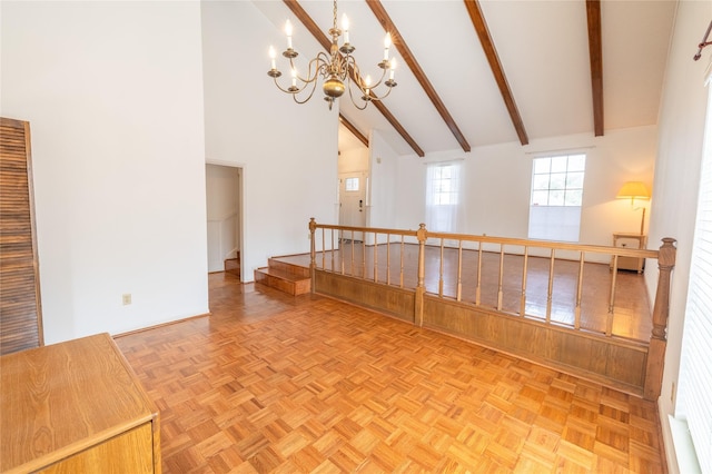 empty room featuring parquet flooring, beam ceiling, and high vaulted ceiling