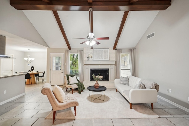 tiled living room featuring beamed ceiling, high vaulted ceiling, a fireplace, and ceiling fan with notable chandelier