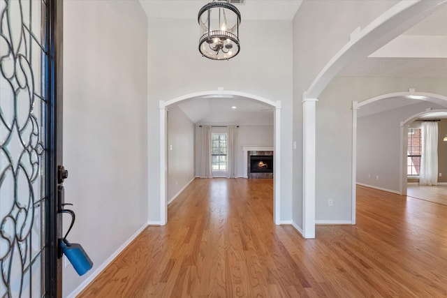 entryway featuring light wood-style floors, a fireplace, and baseboards