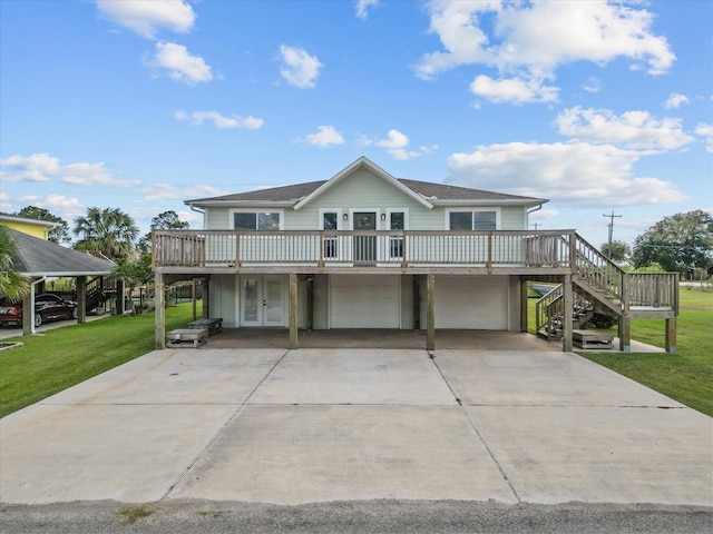 106 Palm Dr Unit Cr776, Liverpool, TX 77577 - beach home with an attached garage, a wooden deck, a front yard, concrete driveway, and french doors