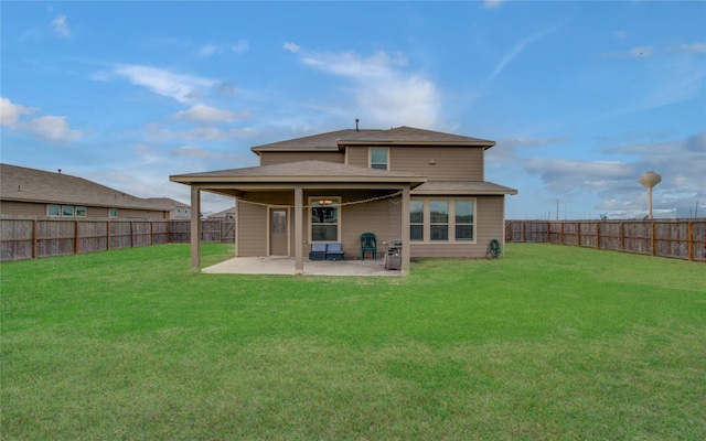 back of house featuring a patio area and a lawn