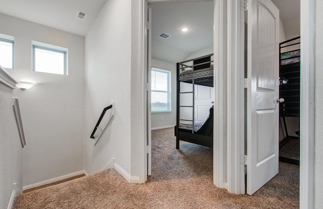 hall featuring light colored carpet