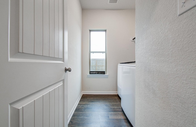 laundry area featuring dark wood-type flooring and washing machine and clothes dryer