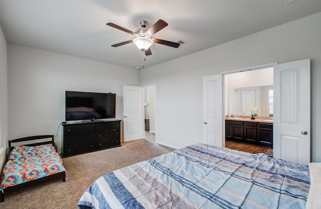 bedroom featuring ceiling fan, ensuite bath, and carpet flooring