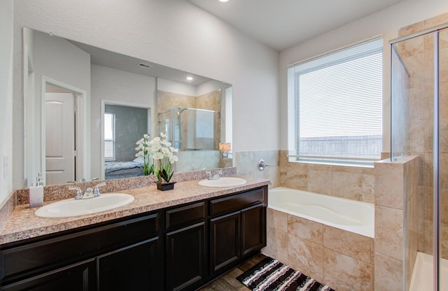 bathroom with vanity and separate shower and tub