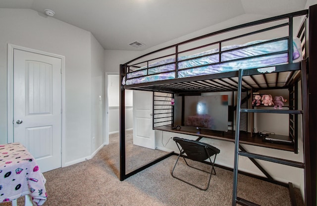 bedroom with vaulted ceiling and carpet