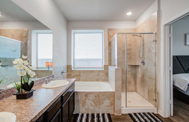 bathroom with vanity and independent shower and bath