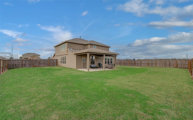 back of house featuring a lawn and a patio