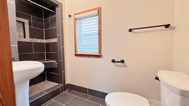3520 Ave S Unit 1/2, Galveston, TX 77550 - bathroom with tile patterned flooring, tiled shower, and toilet