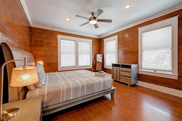 3520 Ave S Unit 1/2, Galveston, TX 77550 - bedroom with hardwood / wood-style flooring, ornamental molding, wooden walls, and ceiling fan