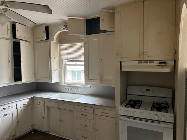 kitchen with sink, white cabinets, and white gas range oven