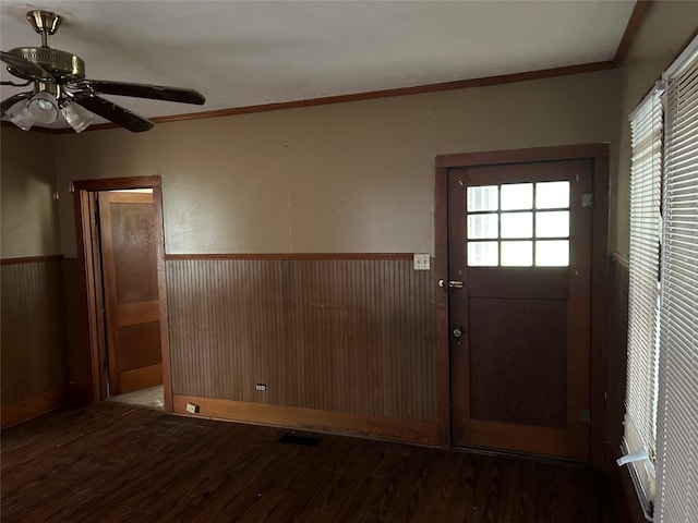 foyer featuring hardwood / wood-style flooring, ceiling fan, crown molding, and wood walls