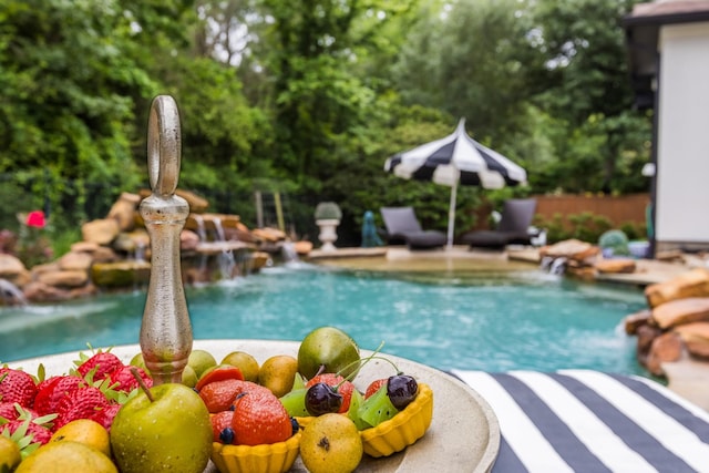 view of swimming pool with a fenced in pool