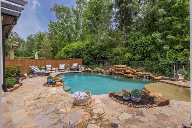 view of swimming pool featuring a patio area, a fenced in pool, and a fenced backyard