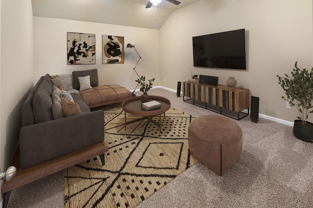 carpeted living room with ceiling fan and vaulted ceiling