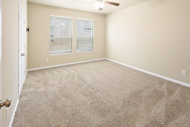 carpeted spare room featuring ceiling fan