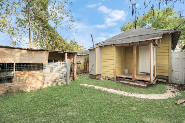 rear view of house with an outdoor structure