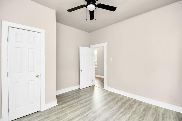 unfurnished bedroom featuring ceiling fan and light hardwood / wood-style flooring