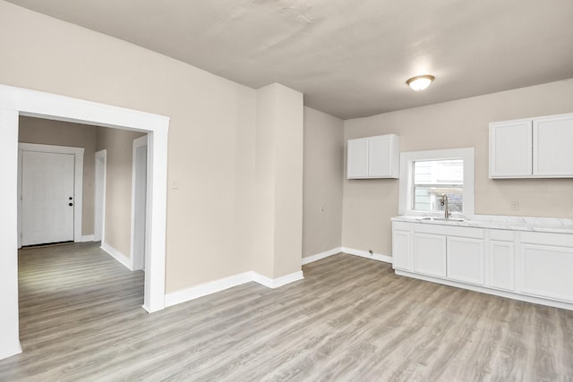 interior space with sink and light hardwood / wood-style flooring