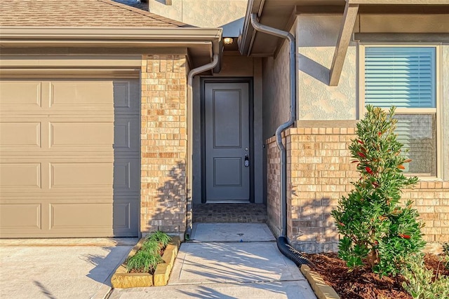 doorway to property with a garage