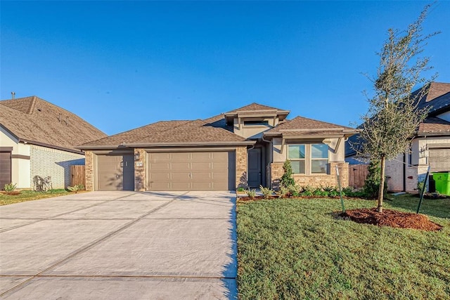 view of front of house with a garage and a front yard