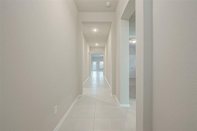 corridor with light tile patterned floors