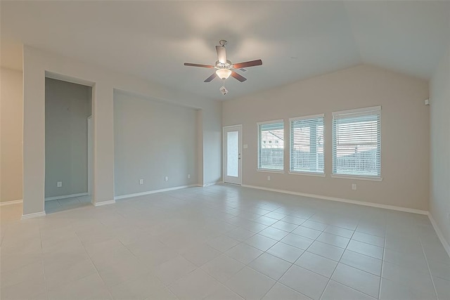 empty room featuring ceiling fan, lofted ceiling, and light tile patterned floors