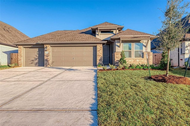 view of front of property featuring a garage and a front yard