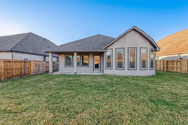 back of house with a lawn and a patio area