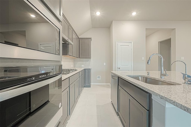 kitchen featuring stainless steel appliances, sink, light tile patterned floors, and gray cabinets