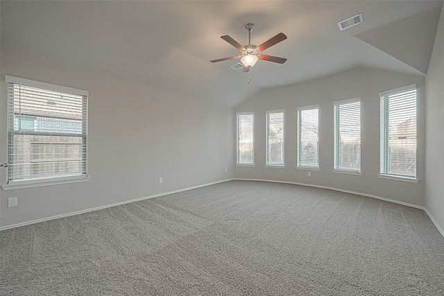 carpeted empty room featuring ceiling fan and vaulted ceiling