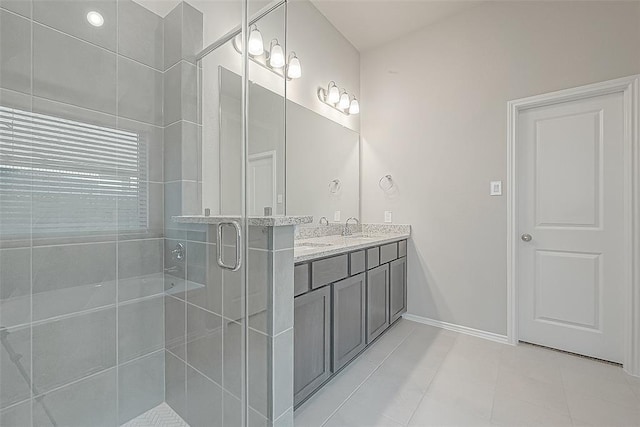 bathroom with walk in shower, tile patterned floors, and vanity