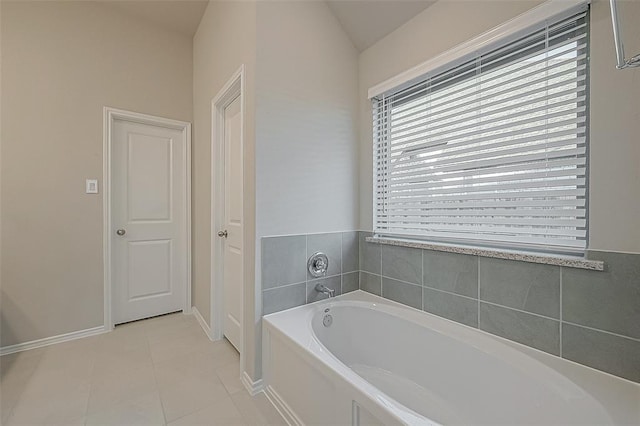 bathroom featuring tile patterned floors and a tub